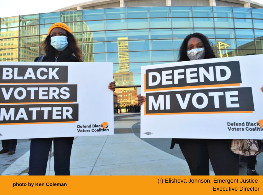 two women holding signs that say black voters matter.